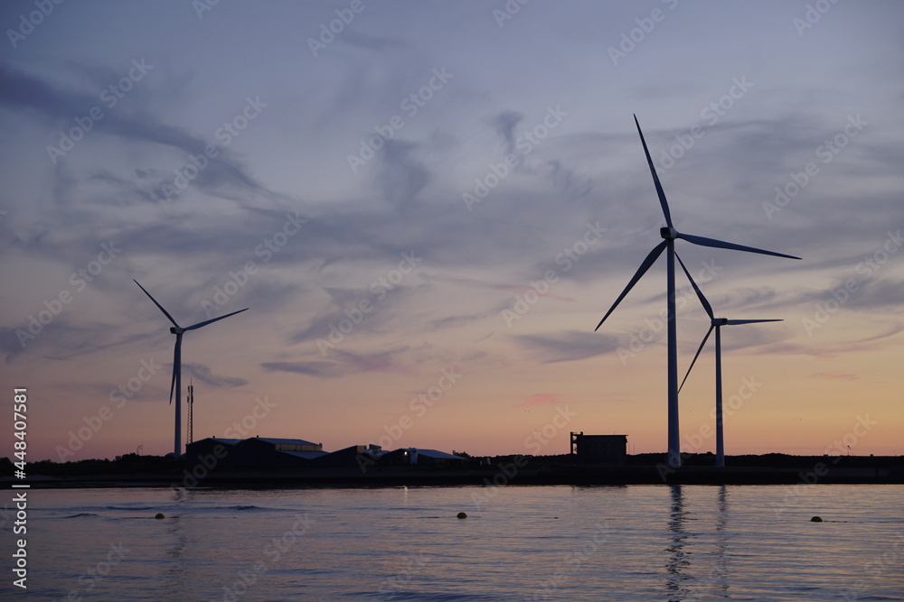 Wall mural windmills at sea by nightfall