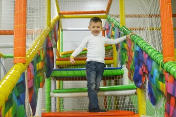 Fototapeta premium Boy Climbing Open Colorful Staircase Successful Childhood Lifestyle Concept.