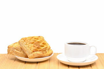 black coffee in white seramic glasses and pineapple pie on  wooden table