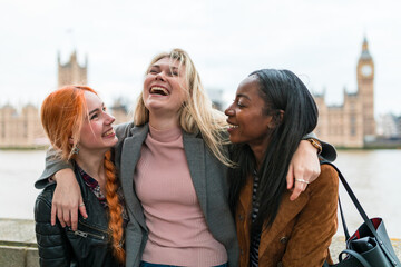 Happy women laughing and having fun together in London - obrazy, fototapety, plakaty
