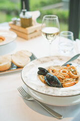 a seafood linguine in a restaurant on a table Italian food