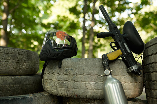 Paintball gun and protection mask closeup