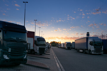 Sun rises over a truck parking lot on the highway