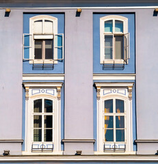 Architectural detail of two blue colored wooden framed windows