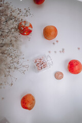 women's cosmetics, rose-colored glasses, peaches, apricots and flowers on a white background