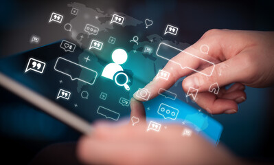 Close-up of a hand using tablet, social media concept