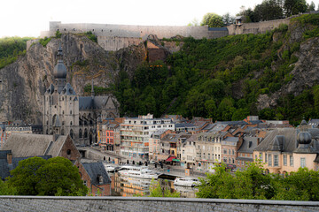 Obraz premium Toeristic pictures of the city Dinant togheter with the River Meuse or Maas. Beautifull clouds, sunsets or blue hours with reflections on the water. Belgium Ardennes toeristic topshots.
