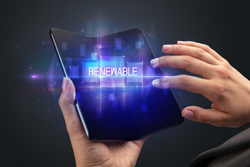 Businessman holding a foldable smartphone