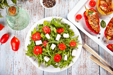 Fresh spring salad with arugula, feta cheese and tomatoes