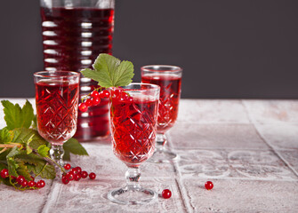 glasses of red currant brandy liqueur with ripe berries
