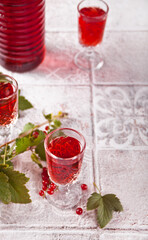 glasses of red currant brandy liqueur with ripe berries
