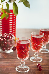 glasses of cherry brandy liqueur with ripe berries