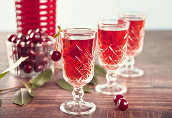 glasses of cherry brandy liqueur with ripe berries