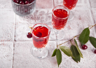 glasses of cherry brandy liqueur with ripe berries