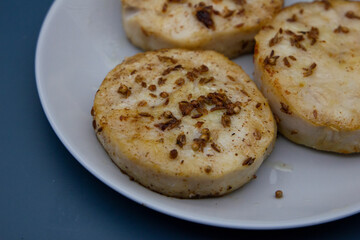 Pan-fried hake fish in the form of medallion fillets sprinkled with cumin and coriander spices.
