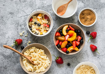 Ingredients for making a summer dessert - plum, nectarines, black currant, strawberry crumble on a gray background, top view