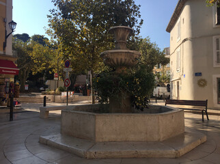 A fountain in Place de la République square on a summer sunny day in the old town of Cassis, located in the Provence-Alpes-Côte d'Azur region, on the French Riviera in Southern France. 