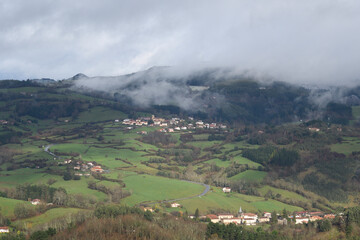 Fototapeta na wymiar Typical landscape of a valley with mist and meadows in the Basque Country