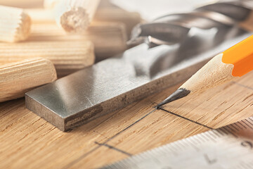pencil, steel ruler drawing on wooden oak board for drilling holes
