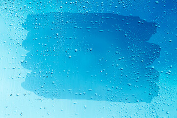 Blue window glass with water drops 