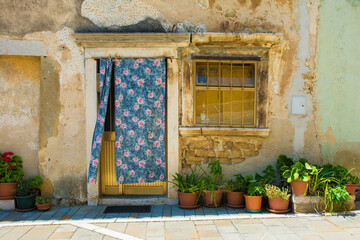 Fototapeta na wymiar A door and window in a old stone residential building in the historic medieval village of Buje in Istria, Croatia 