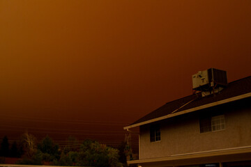 Fototapeta na wymiar Smoky orange sky over a home in Redding, California from California fires in September 2020 in the Western United States.