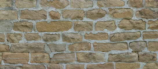 Wild-stone texture. Brown stone masonry background panorama.