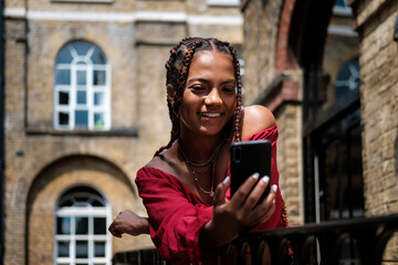 Young woman with smart phone taking selfie.