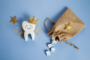 National Tooth Fairy Day. Children tooth fairy. Cute tooth with wings, a crown and a magic wand and...