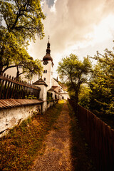 Church in The Spania Dolina village with mining landscape, Slovakia, Europe. - obrazy, fototapety, plakaty