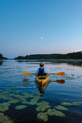 kayaking in sea in finland summer night time kayaking on a kayak summer holiday fun travel to...