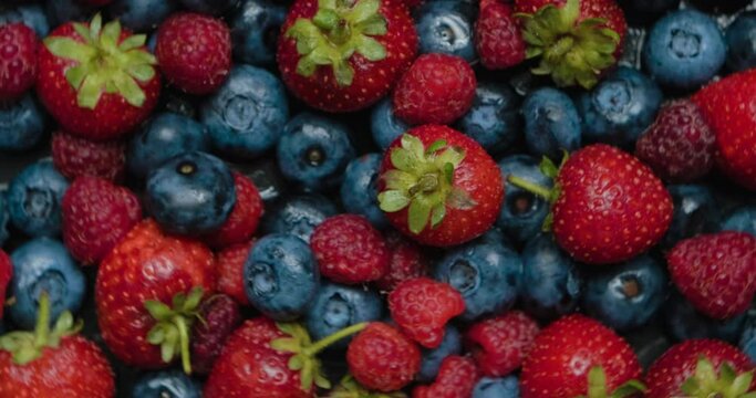 Summer berries, strawberries, raspberries and blueberries. Various colorful berries rotation.
