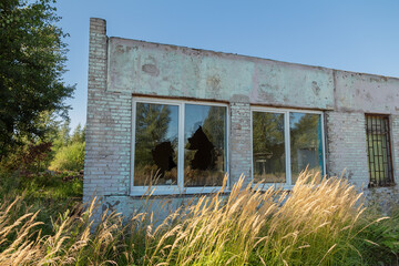 Fototapeta na wymiar Broken windows in an abandoned building