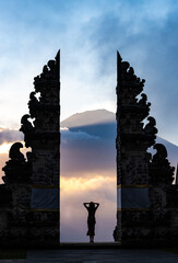 A silhouette of a woman admiring a sunset