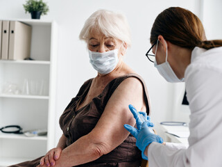 Nurse giving an injection to the patient's shoulder covid-19 vaccination passport