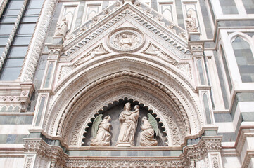Fototapeta na wymiar Florence Cathedral, Cathedral of Saint Mary of the Flower (Cattedrale di Santa Maria del Fiore), one of sculpture over gates