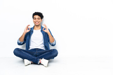 Venezuelan man sitting on the floor in zen pose