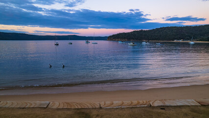 Fototapeta na wymiar Peaceful sunrise over the bay with boats