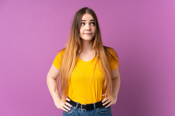Young caucasian woman isolated on purple background angry