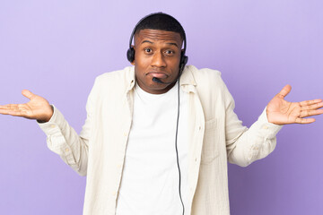 Telemarketer latin man working with a headset isolated on purple background having doubts while...