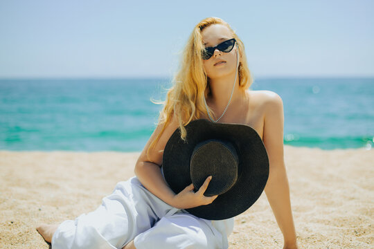 Pretty Woman On The Ocean Beach Enjoying Her Summer Vacation, Arms  Stretched Out Towards The Sun As A Symbol Of Freedom Stock Photo, Picture  and Royalty Free Image. Image 18062760.