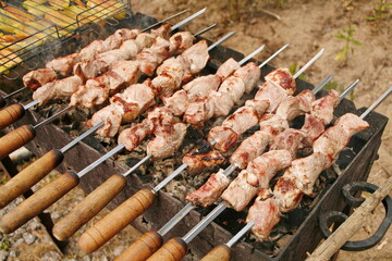 Marinated shashlik preparing on a barbecue grill over charcoal. Shashlik or Shish kebab popular in Eastern Europe