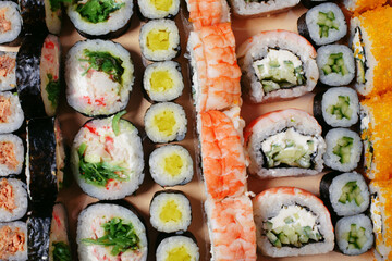 Maki and nigiri, sushi with fish, fresh salmon, shrimp and cheese, avocado rolls. Futomaki and Philadelphia with California. Set sushi