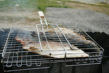 Grill with freshly cooked fish. cooking fish trout on the grill