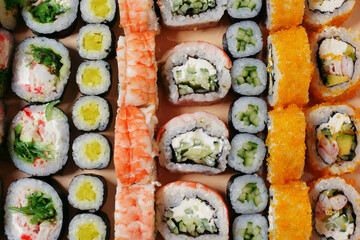Maki and nigiri, sushi with fish, fresh salmon, shrimp and cheese, avocado rolls. Futomaki and Philadelphia with California. Set sushi