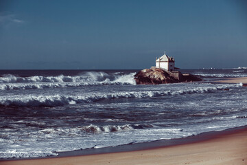 View of the Atlantic Ocean and Chapel Senhor da Pedra on the coast, Vila Nova de Gaia, Portugal.
