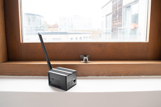 Helium hotspot cryptocurrency miner next to a window in a home.