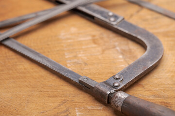 Obraz premium Old vintage metal hacksaw blade close up. Background for craftsmanship and manual labor.