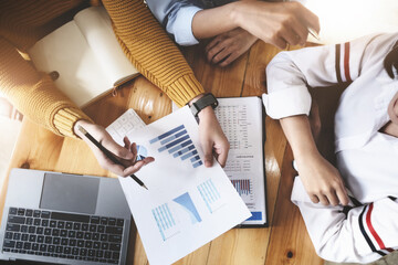 The auditor hand holding pen and budget graph document to examine the misuse of company funds.