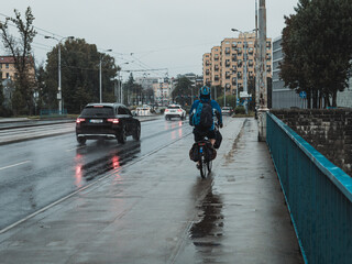 cycling in the rain, streets of the city